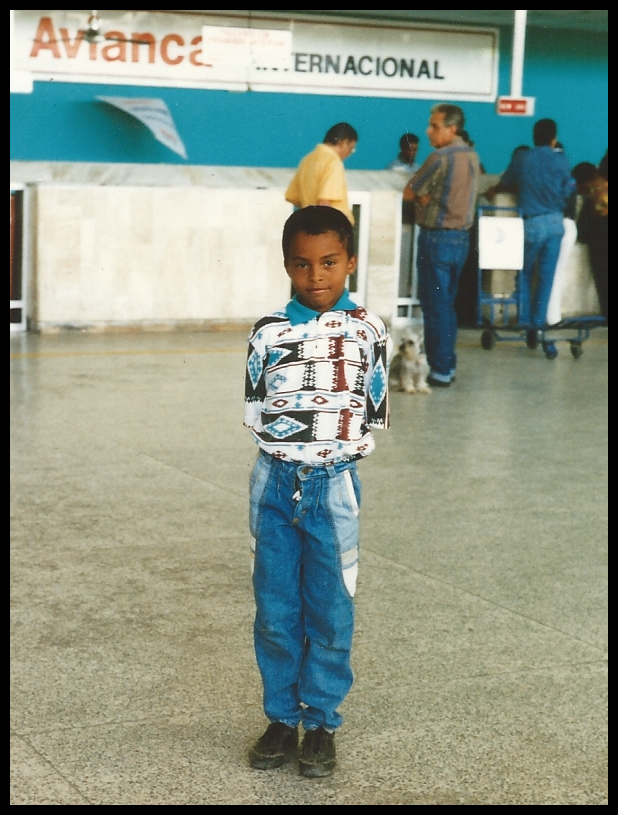 10 year old Fabi&eacute;n all neat
              with tight curls and aqua pants and shirt