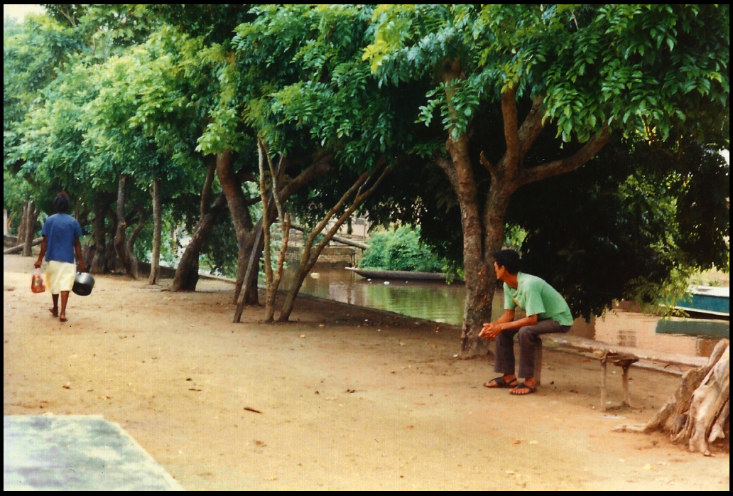 nneighborhood men's bench at the house
          next door to Yazm&iacute;n's, plus canal with dugout canoe of
          hollowed-out tree trunk, taken by the Dr. from her porch where
          he wrote so much of this diary