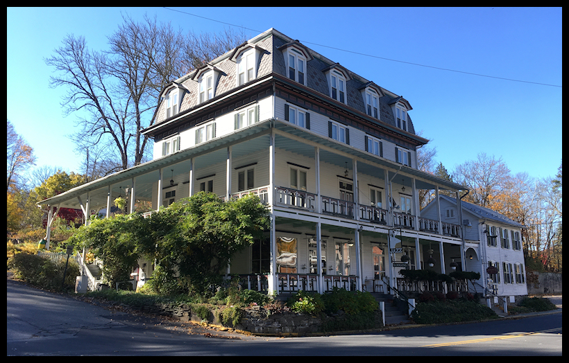 elegant white
              turn-of-the-century four-storey Poconos inn with big
              windows, railinged porches and a cute colonial-style
              sidehouse
