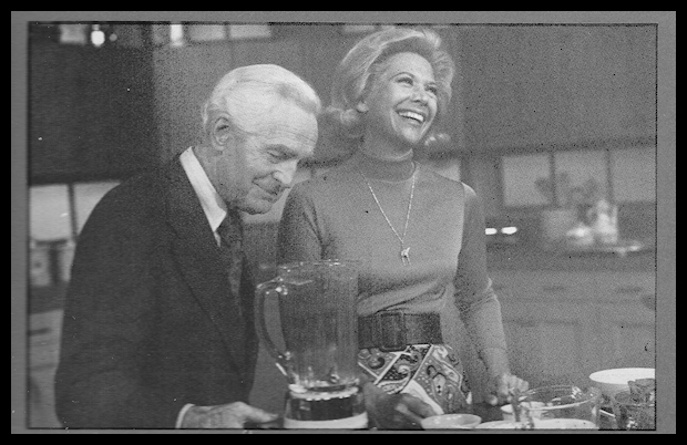 black and white photo:
              Fred show Dinah Shore his Blendor