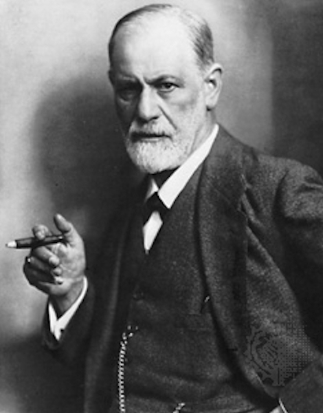 Freud: professional
              photo portrait in black and white, cigar in hand, neatly
              trimmed white beard, watch fob chain hung correctly, stern
              gaze into camera