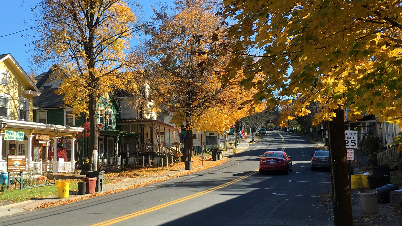 two-way street lined both sides with
              lovely big old houses, all painted yellow by leaves in
              trees and on ground