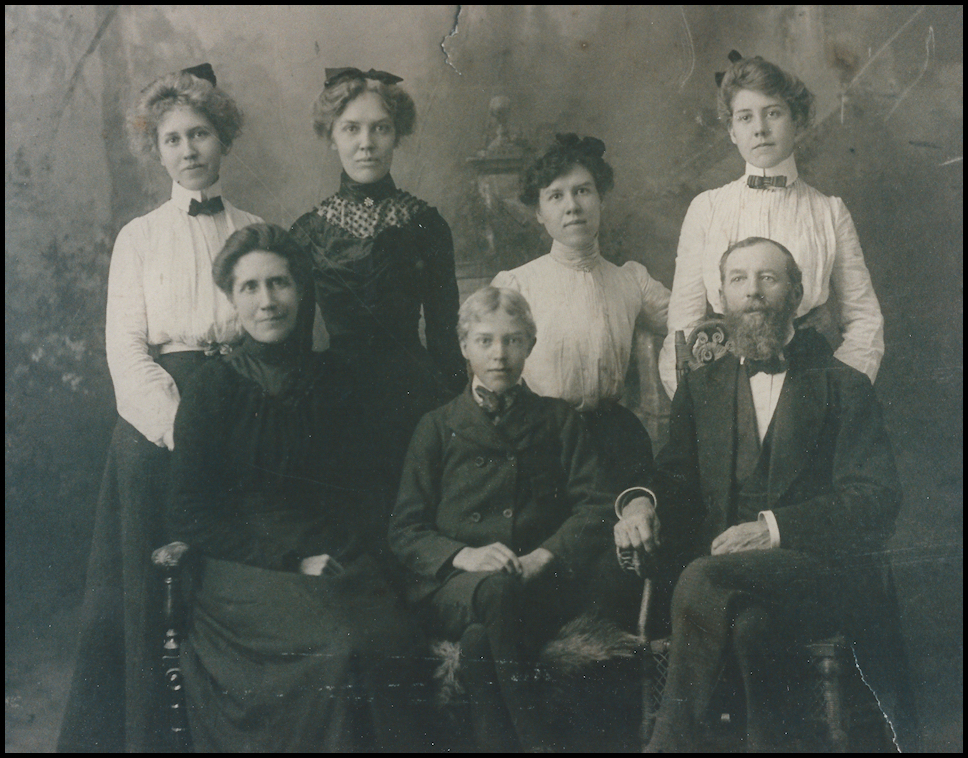 old black and
            white photo: lovely late-Victorian blouses and bows on four
            20-ish sisters standing behind parents and their coddled and
            wide-eyed 14-year-old brother, the Dr.'s (great) 'Uncle
            John', family jokesmith and storyteller